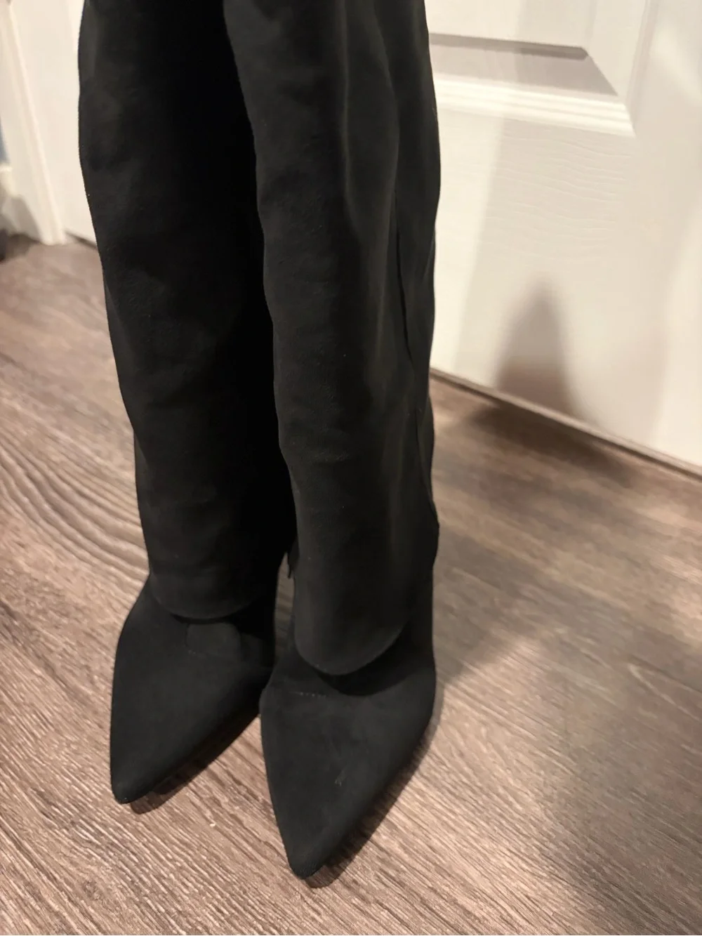 Black suede boots with pointed toe and stiletto heel